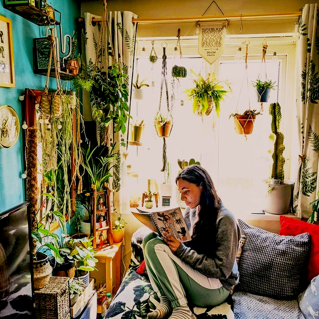 girl reading in a room full of plants