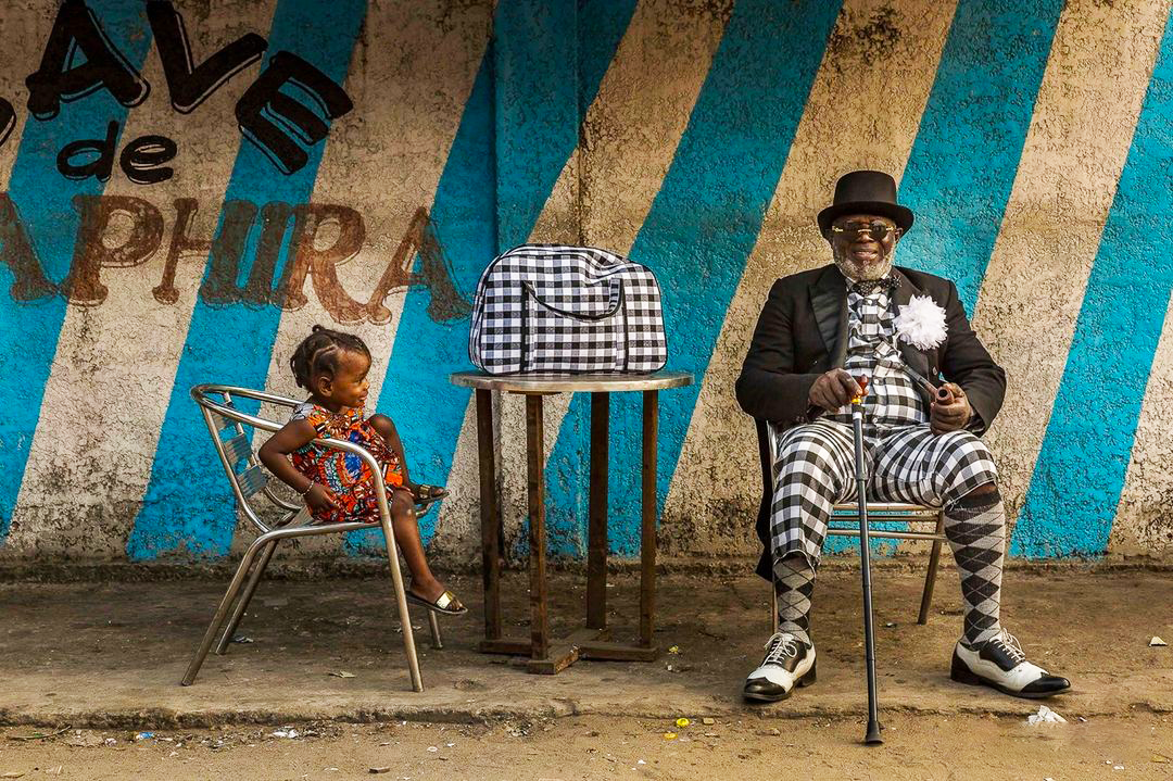 Congolese Sapeur Sitting with Child