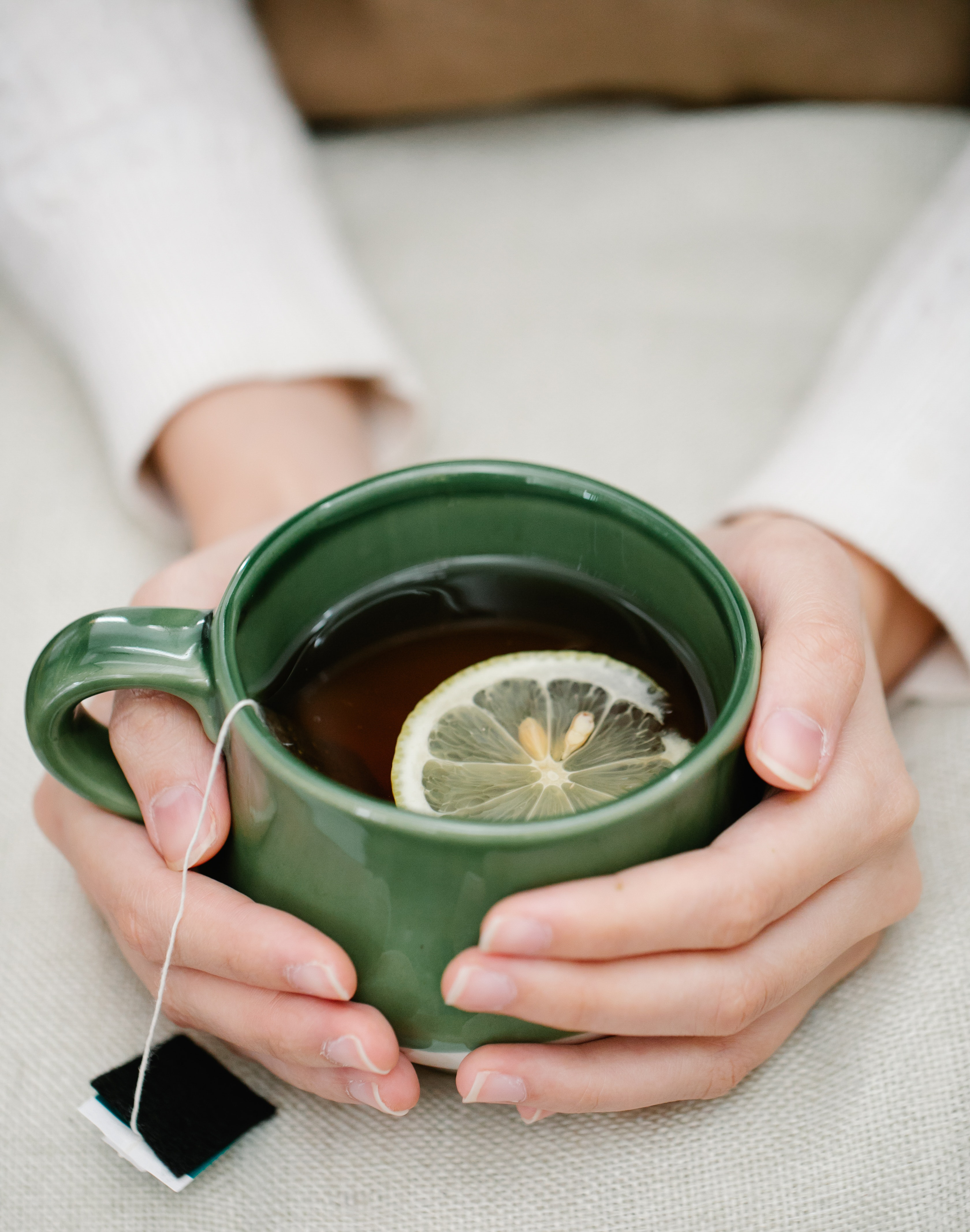 Hands holding cup