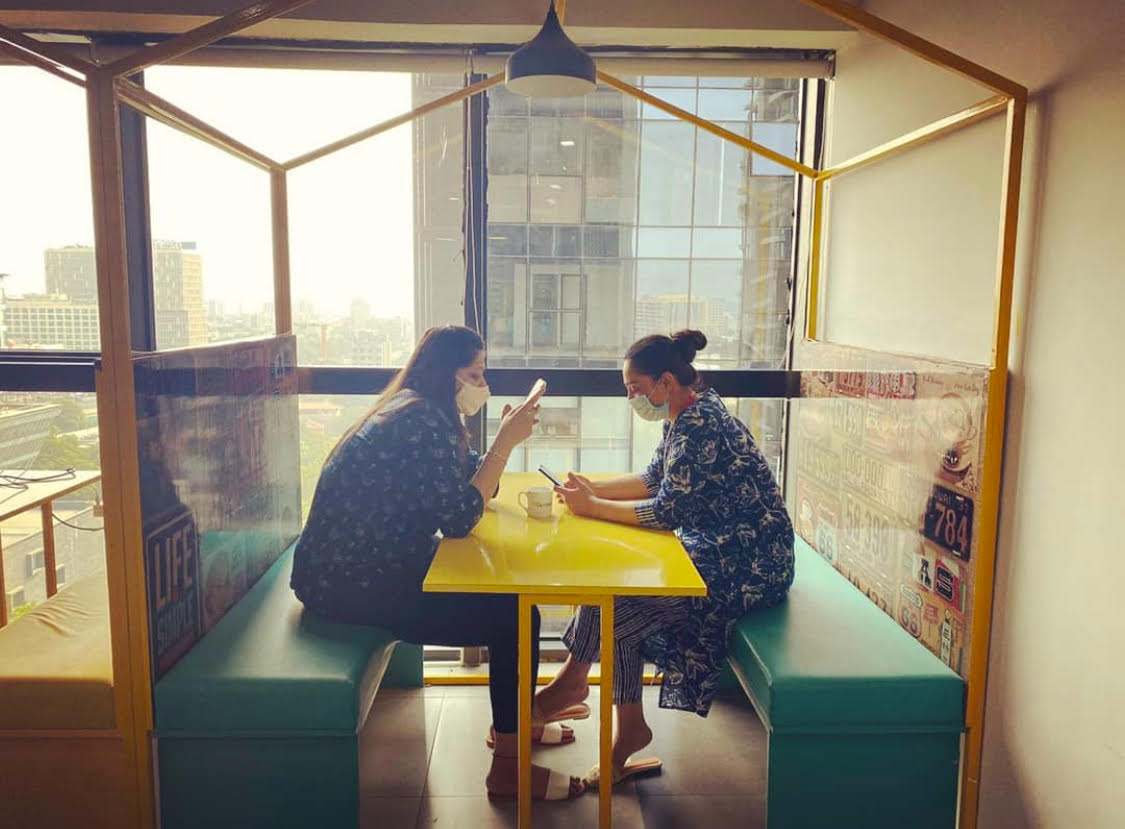 two women sitting in a office cafe