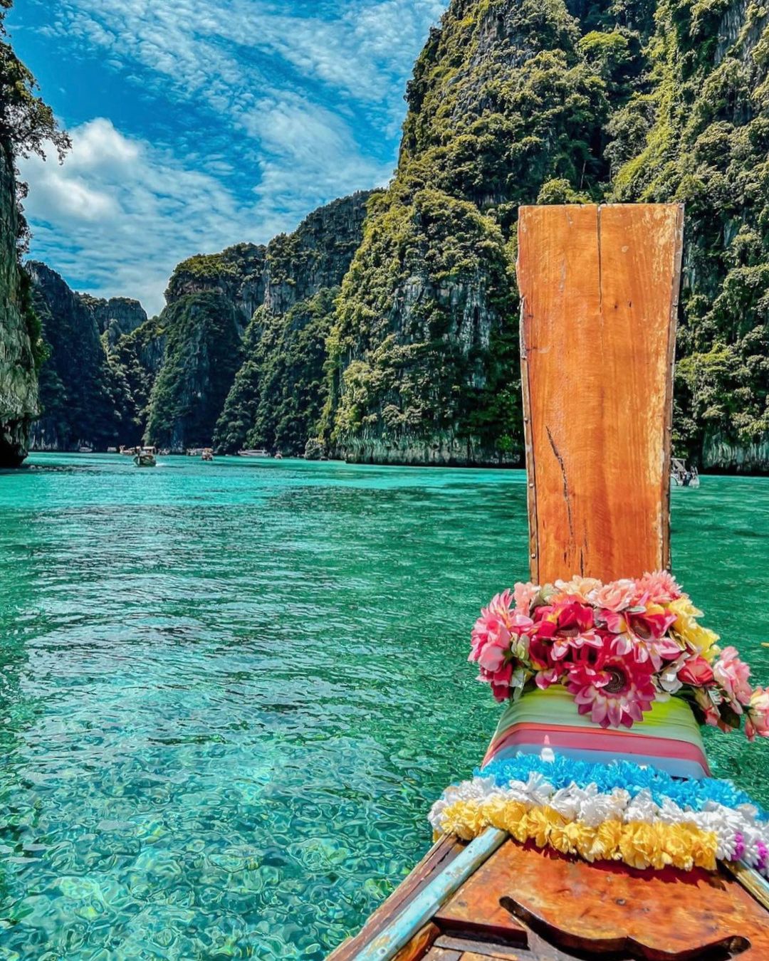 A view of a beautiful island from a colourful boat