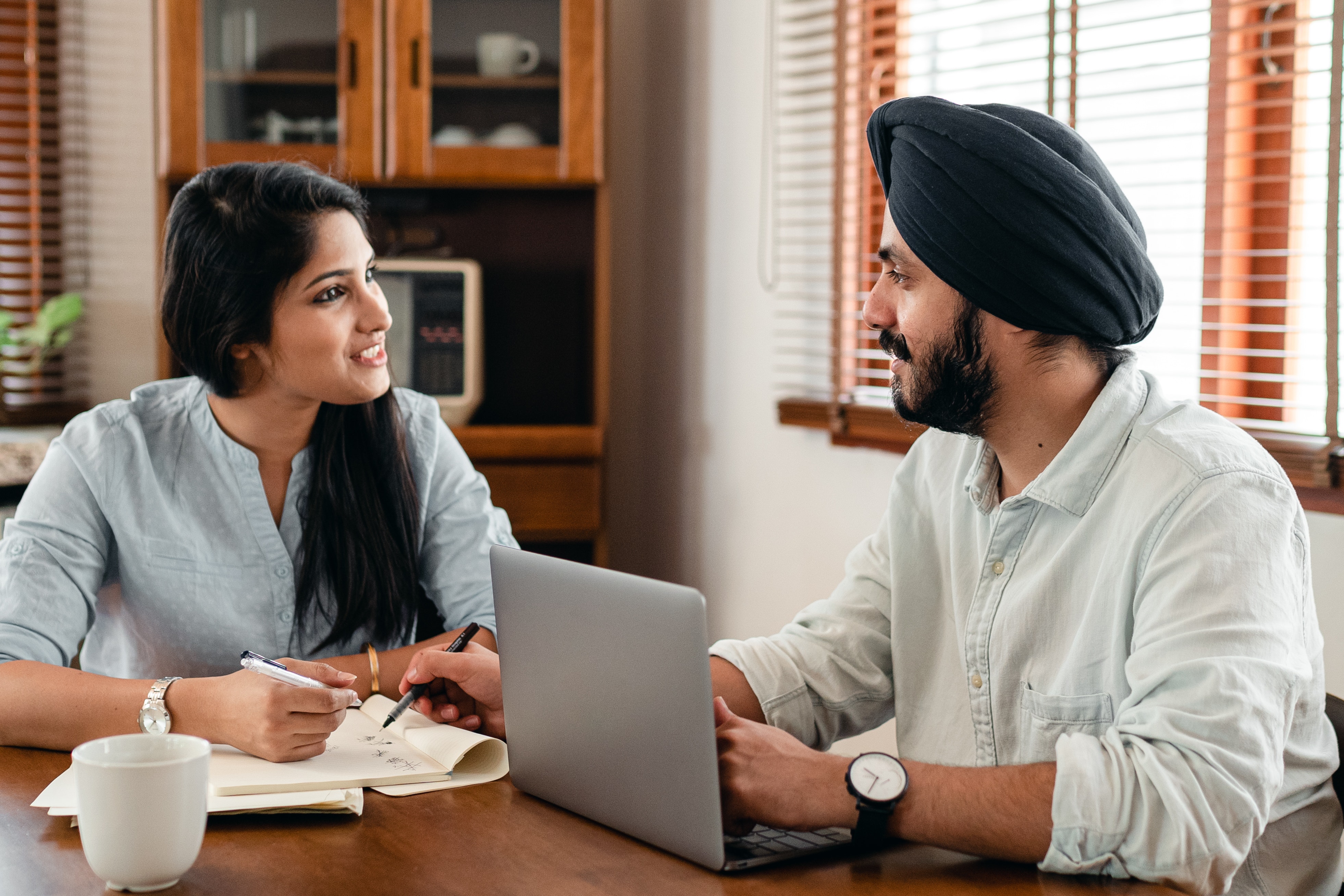 A woman and sikh man at work