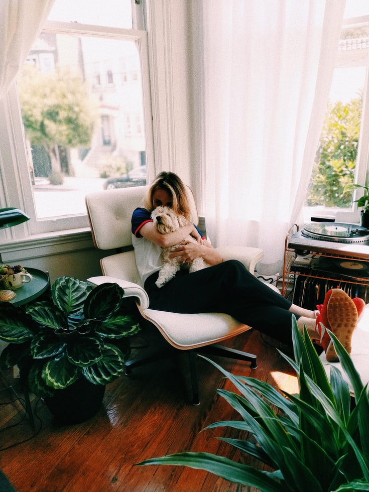 A girl at her home reading a book