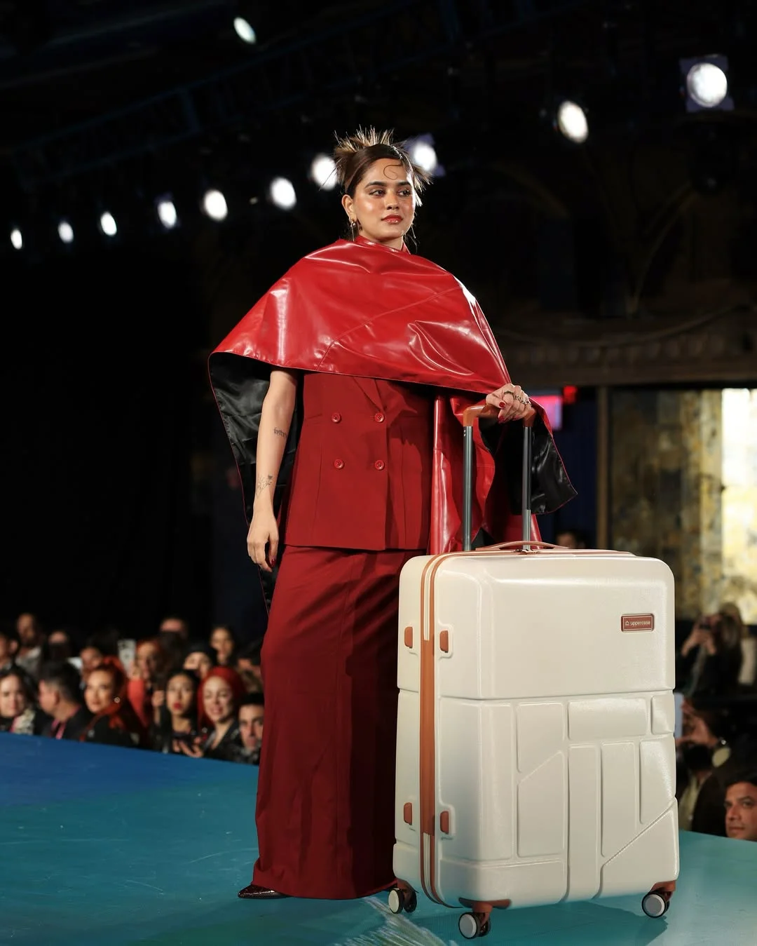 An image of a model on the runway of NYFW with the uppercase suitcase